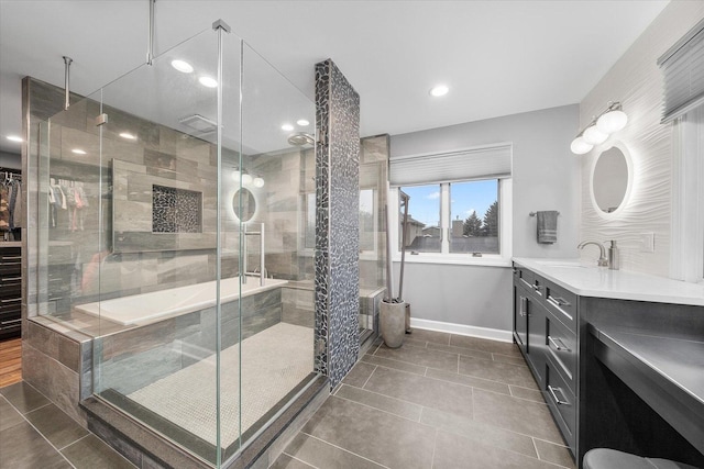 bathroom with tile patterned flooring, a stall shower, vanity, and baseboards