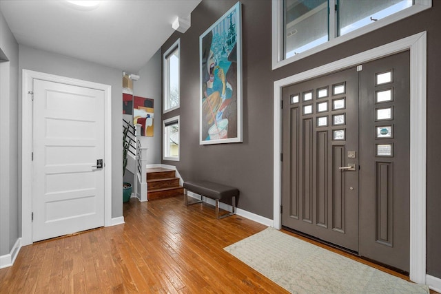 entrance foyer featuring stairway, baseboards, and hardwood / wood-style flooring