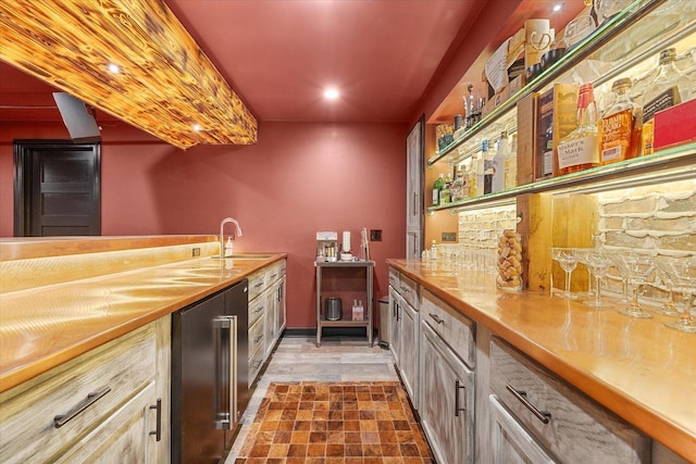 bar with a sink, wet bar, and wine cooler