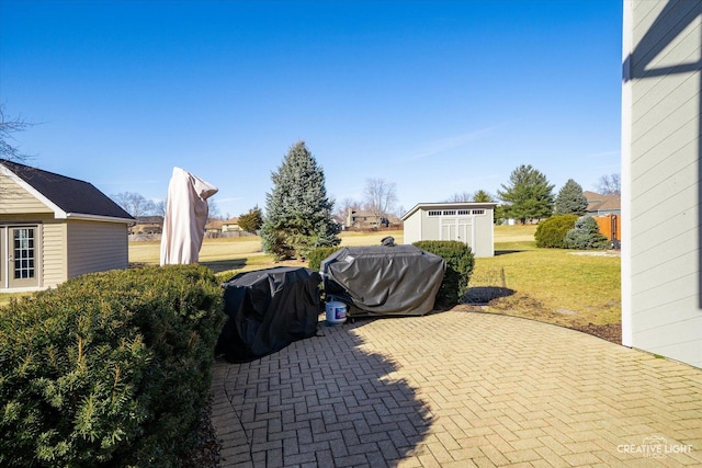 view of patio / terrace featuring grilling area and an outdoor structure