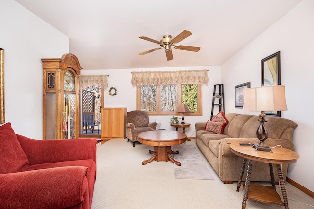 carpeted living room with ceiling fan and baseboards