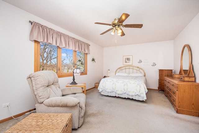 bedroom featuring baseboards, ceiling fan, and light colored carpet