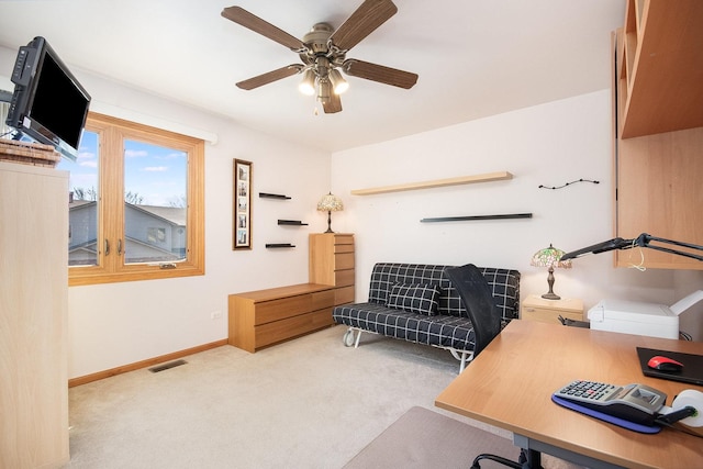 carpeted office featuring a ceiling fan, visible vents, and baseboards