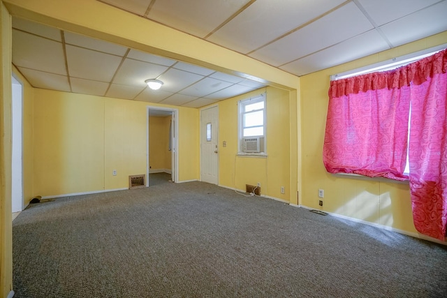 carpeted spare room featuring cooling unit, a paneled ceiling, and visible vents