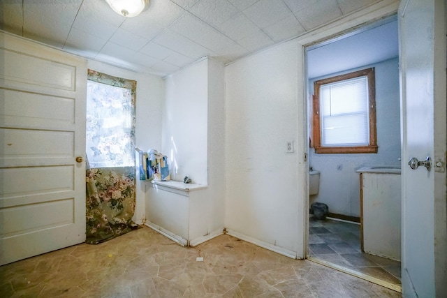 laundry room featuring a healthy amount of sunlight and baseboards