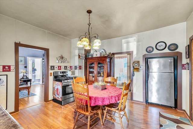 dining space with an inviting chandelier and light wood-style floors