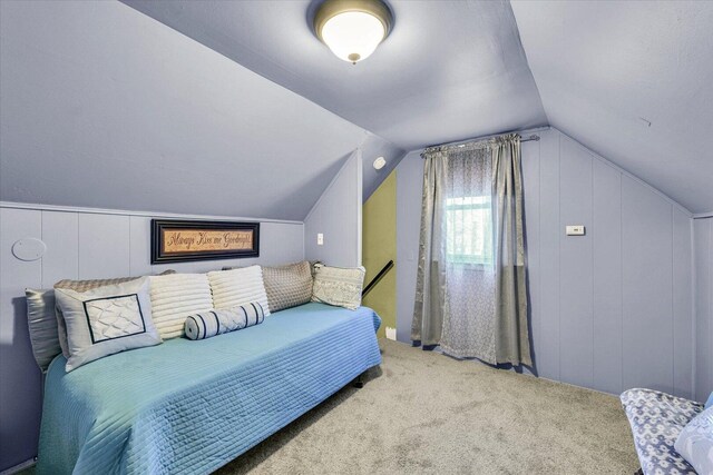 bedroom featuring vaulted ceiling and carpet floors