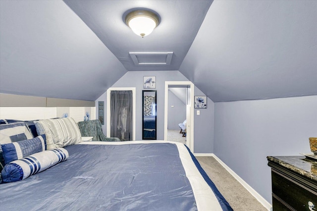 bedroom with attic access, carpet flooring, baseboards, and vaulted ceiling