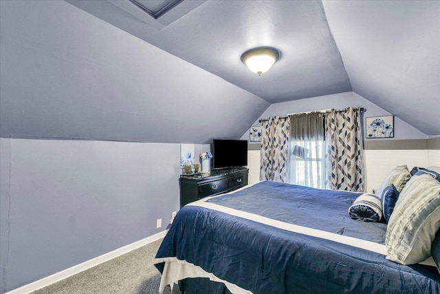 carpeted bedroom with baseboards and lofted ceiling