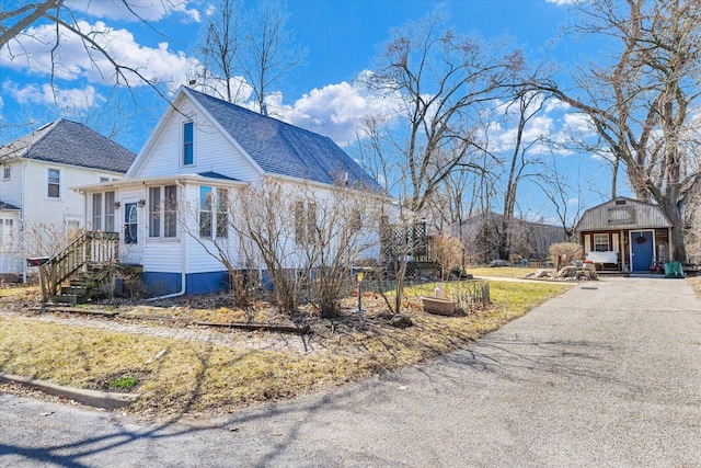 view of property exterior with a shingled roof