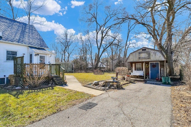 view of yard featuring a porch and a fire pit