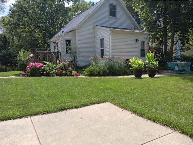 view of property exterior featuring a lawn