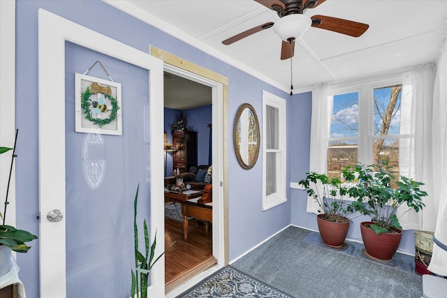 interior space with baseboards and ceiling fan