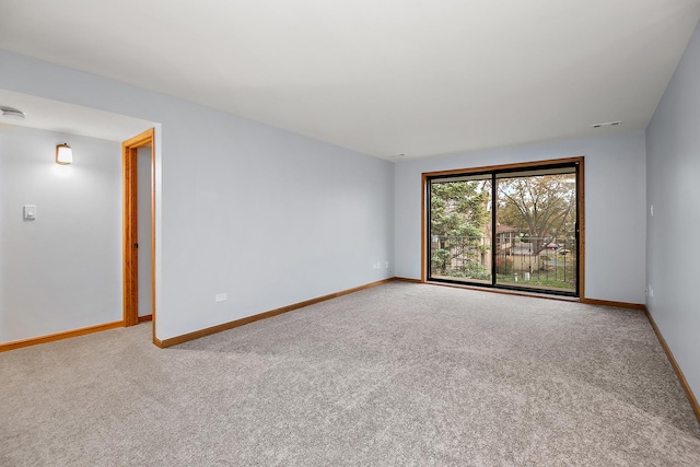 empty room with carpet flooring and baseboards