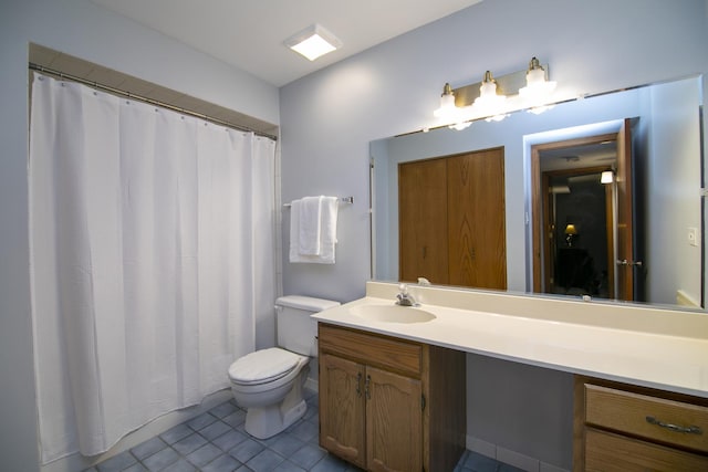 bathroom with toilet, tile patterned floors, curtained shower, and vanity