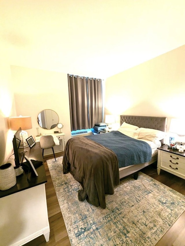 bedroom with dark wood finished floors