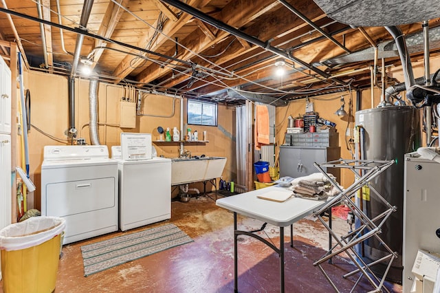 basement with water heater, independent washer and dryer, and a sink