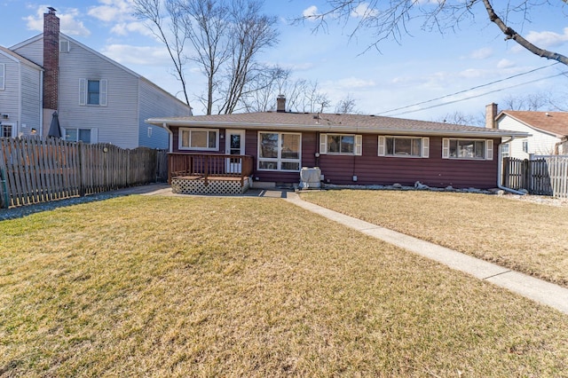 single story home featuring a fenced backyard, a chimney, and a front yard