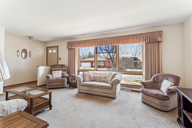 living room with visible vents, carpet flooring, a wealth of natural light, and baseboards