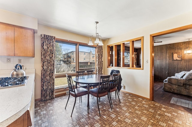 dining area with wood walls and baseboards