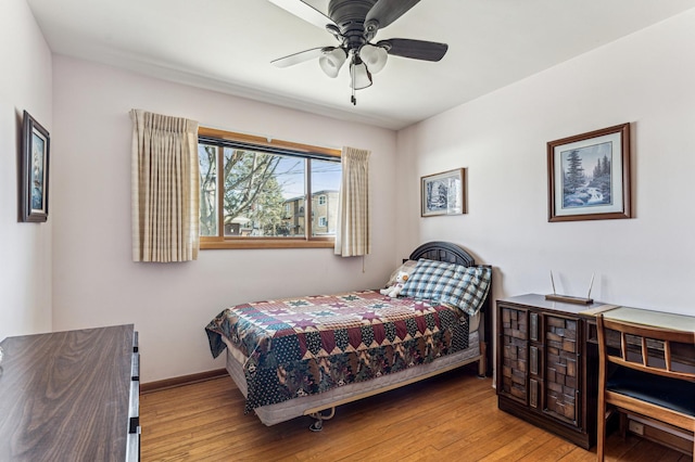 bedroom with baseboards and hardwood / wood-style floors