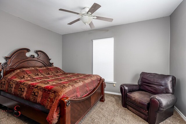 bedroom with light colored carpet, a ceiling fan, and baseboards