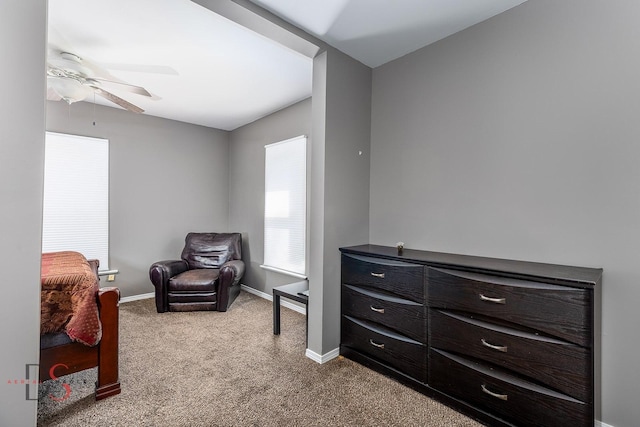 sitting room featuring baseboards, a ceiling fan, and carpet flooring