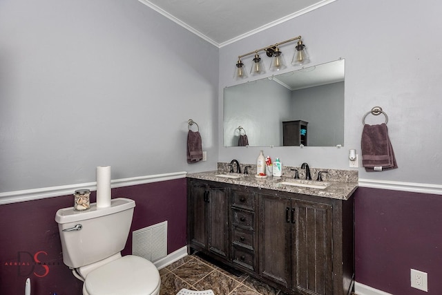 bathroom featuring visible vents, a sink, crown molding, and toilet