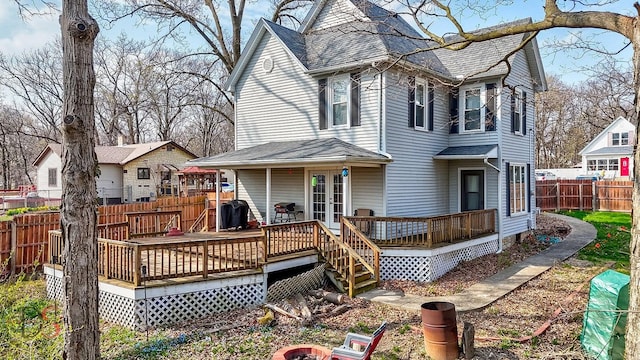back of house with a fenced backyard, a wooden deck, and a shingled roof