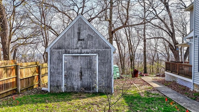 view of shed featuring fence