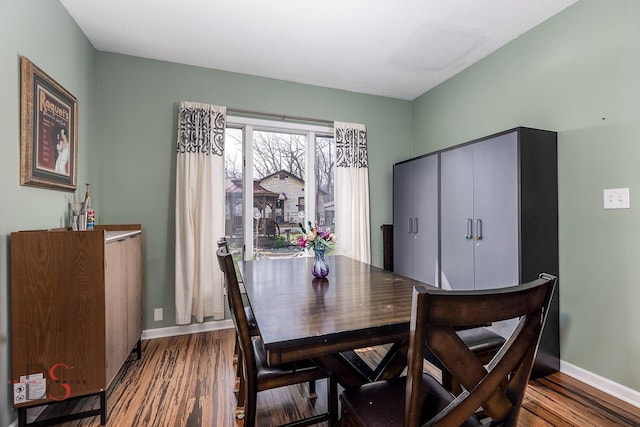 dining area featuring baseboards and wood finished floors