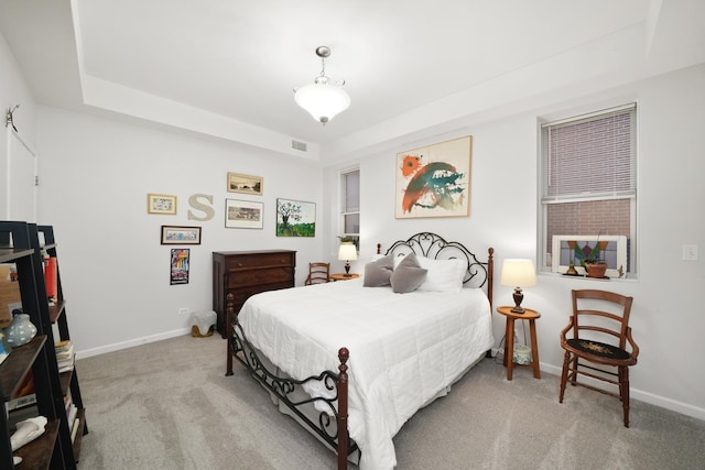 bedroom with carpet floors, visible vents, and baseboards