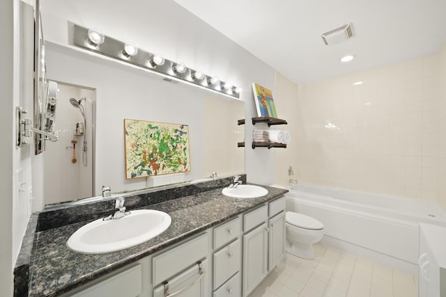 bathroom with visible vents, a sink, toilet, and double vanity