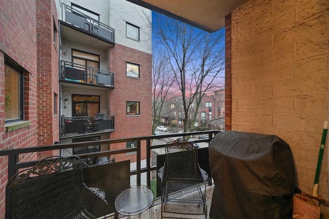 balcony at dusk with a grill