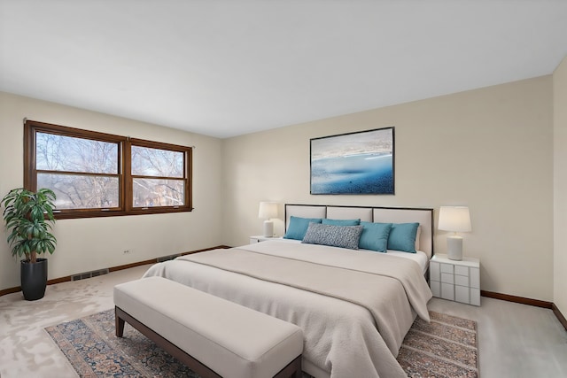 bedroom featuring light colored carpet, visible vents, and baseboards