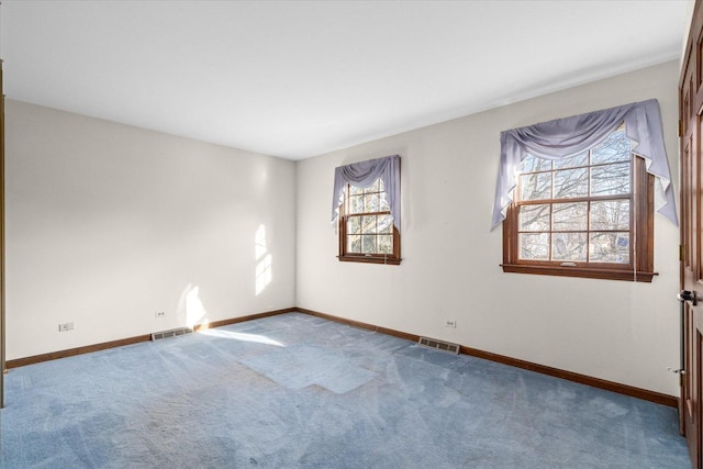 spare room featuring visible vents, baseboards, and carpet