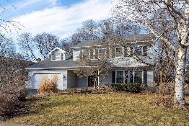 traditional-style house featuring a garage and a front lawn