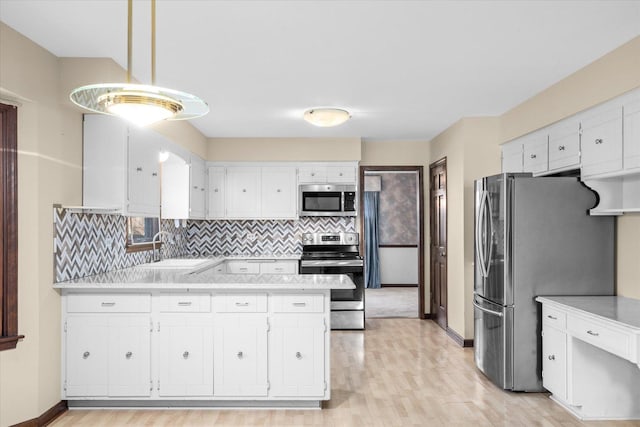 kitchen featuring a sink, white cabinetry, appliances with stainless steel finishes, and light countertops