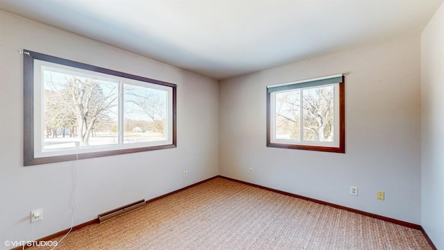 unfurnished room featuring light carpet and baseboards