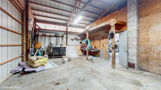 garage with a workshop area and metal wall