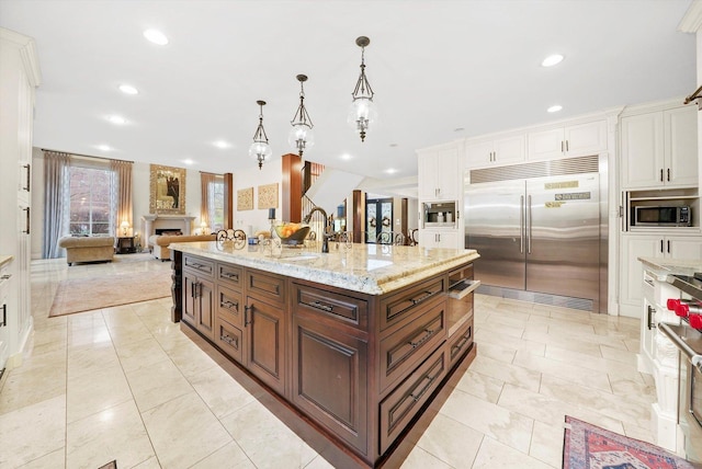 11735 Orchard St, Willow Springs, IL 60480 - kitchen featuring white cabinets, built in appliances, a sink, and recessed lighting