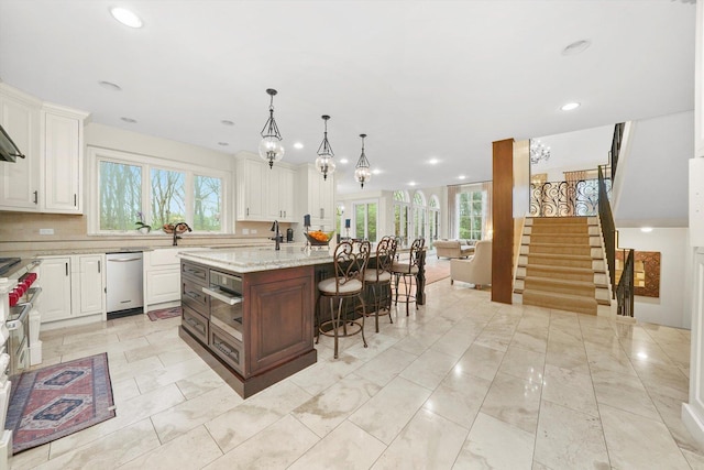 11735 Orchard St, Willow Springs, IL 60480 - kitchen featuring recessed lighting, a breakfast bar area, a center island with sink, open floor plan, and white cabinetry