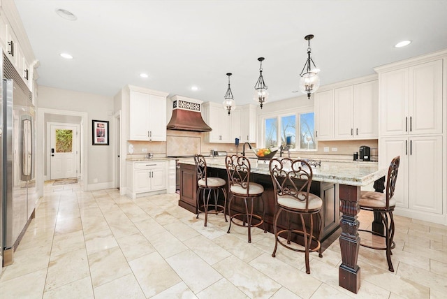11735 Orchard St, Willow Springs, IL 60480 - kitchen featuring premium range hood, stainless steel built in fridge, a kitchen breakfast bar, and plenty of natural light