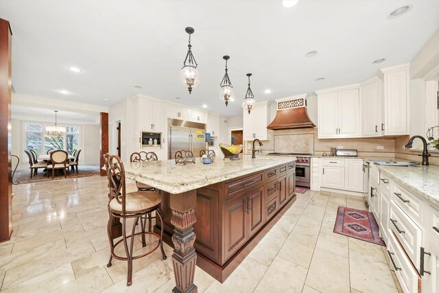 11735 Orchard St, Willow Springs, IL 60480 - kitchen featuring a kitchen bar, high quality appliances, a sink, premium range hood, and white cabinets