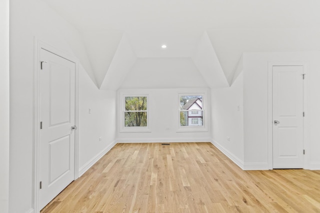 additional living space with lofted ceiling, light wood-style floors, baseboards, and recessed lighting