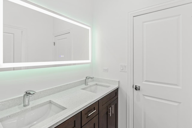 full bathroom featuring double vanity and a sink