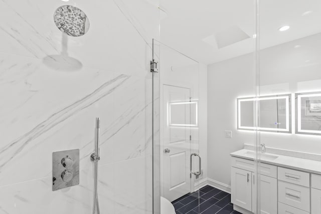 bathroom featuring recessed lighting, a marble finish shower, baseboards, and vanity