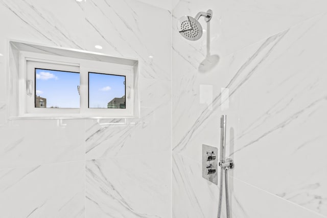 interior space featuring a marble finish shower