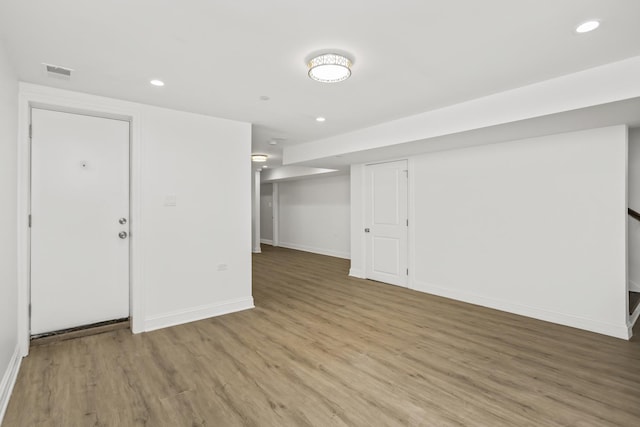 finished basement featuring recessed lighting, baseboards, visible vents, and light wood finished floors