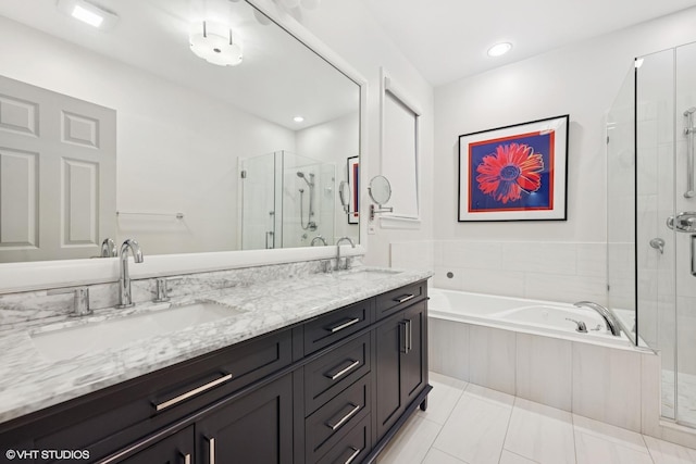 full bath featuring double vanity, a shower stall, a garden tub, and a sink